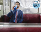 <p>Frost takes a moment to hydrate on a quick subway ride beneath the Capitol Complex. The Capitol subway system consists of three private lines that allow members to quickly travel between their offices without going above ground. This particular subway line was built in 1965, and the people-mover's signature red seats have been occupied by a number of legends over the years.</p>