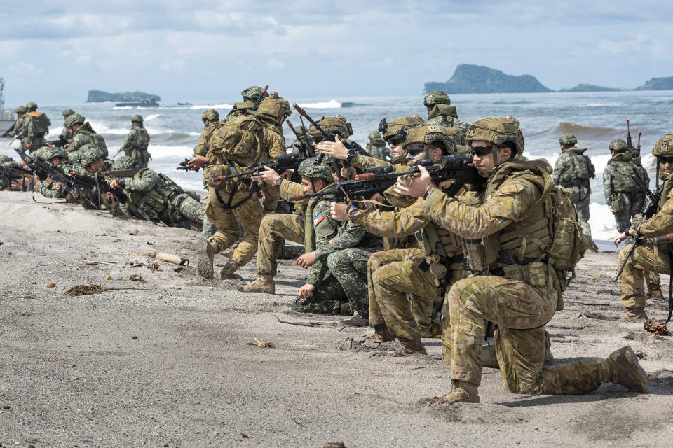 In this photo released by Australian Department of Defense via Australian Embassy in the Philippines, Australian Army soldiers from the 1st Battalion, the Royal Australian Regiment and Armed Forces of the Philippines soldiers conduct a large-scale combined amphibious assault exercise on Friday, Aug. 25, 2023, at a naval base in San Antonio, Zambales, Philippines. The Philippines and Australia, while also backed by the United States Marine Corps, are holding a bilateral amphibious training called "Exercise Alon 2023," coined from Tagalog word meaning "wave," which is aimed at enhancing interoperability and preparedness to respond to security challenges in the Indo-Pacific region. (Riley Blennerhassett/Australian Department of Defense via AP)