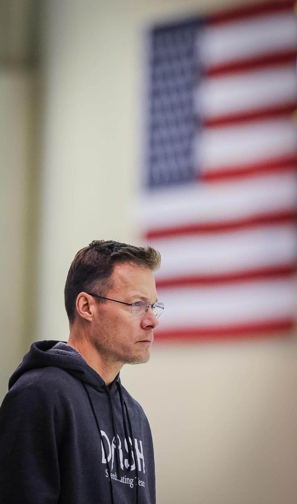 David Cruikshank watches one of the skaters he coaches prepare to race in the men’s 5,000 meters at the U.S. Speedskating long-track national championships Thursday, January 5, 2023, at the Pettit Center in Milwaukee, Wisconsin.