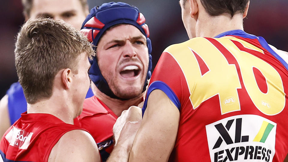 Angus Brayshaw scuffles with a Brisbane Lions opponent during their round 23 clash.