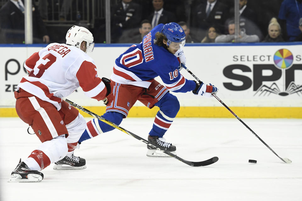 New York Rangers left wing Artemi Panarin (10) skates with the puck as Detroit Red Wings defenseman Alex Biega (3) defends during the second period of an NHL hockey game Friday, Jan. 31, 2020, in New York. (AP Photo/Sarah Stier)