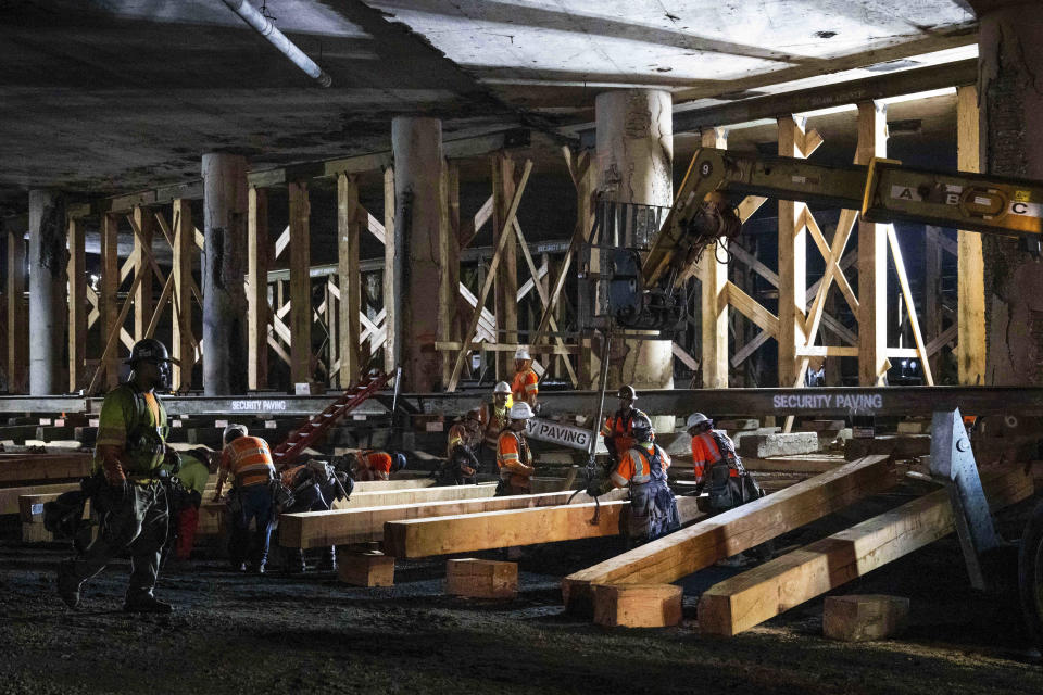 Construction crews shore up the fire-damaged 10 Freeway in Los Angeles on Thursday evening, Nov. 16, 2023. Gov. Gavin Newsom says the freeway will open next week earlier than estimated. (Sarah Reingewirtz/The Orange County Register via AP)