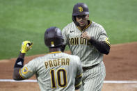 San Diego Padres Jurickson Profar, left, greets Trent Grisham, right, after Grisham's home run in the fourth inning during a baseball game on Sunday, April 11, 2021, in Arlington, Texas. (AP Photo/Richard W. Rodriguez)