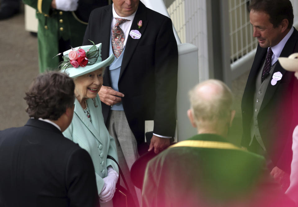 Britain's Queen Elizabeth II speaks to Sir Francis Brooke, left and other racegoers, during day five of of the Royal Ascot horserace meeting, at Ascot Racecourse, in Ascot, England, Saturday June 19, 2021. (Steven Paston/PA via AP)