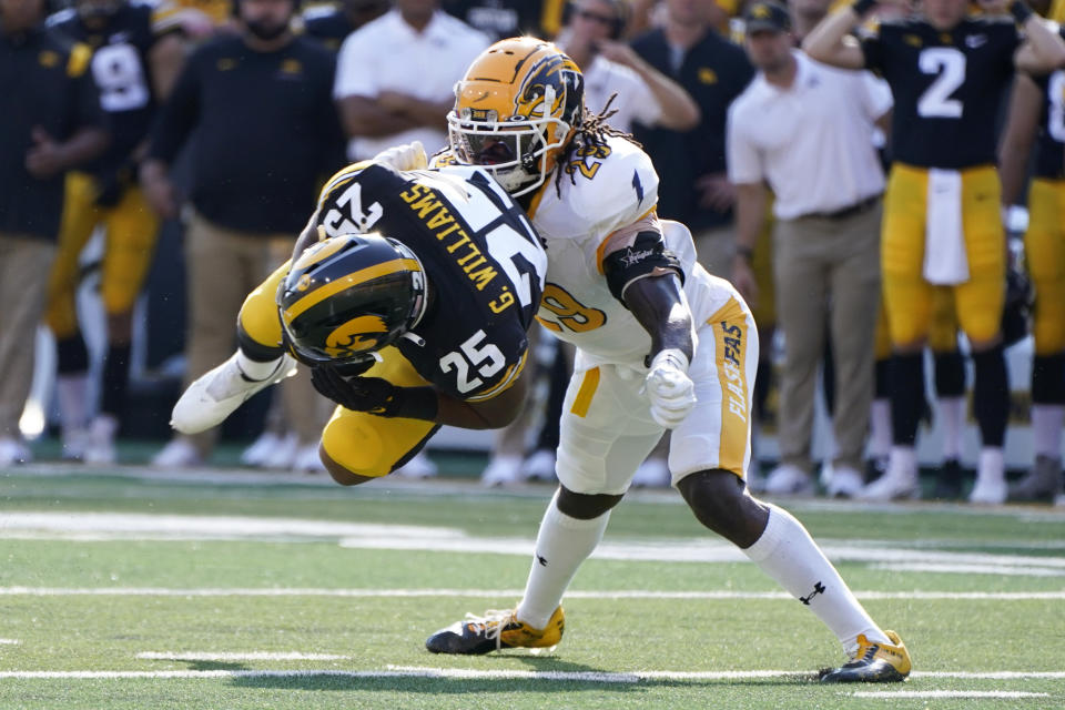 Iowa running back Gavin Williams (25) catches a pass ahead of Kent State safety C.J. Holmes (29) during the first half of an NCAA college football game, Saturday, Sept. 18, 2021, in Iowa City, Iowa. (AP Photo/Charlie Neibergall)