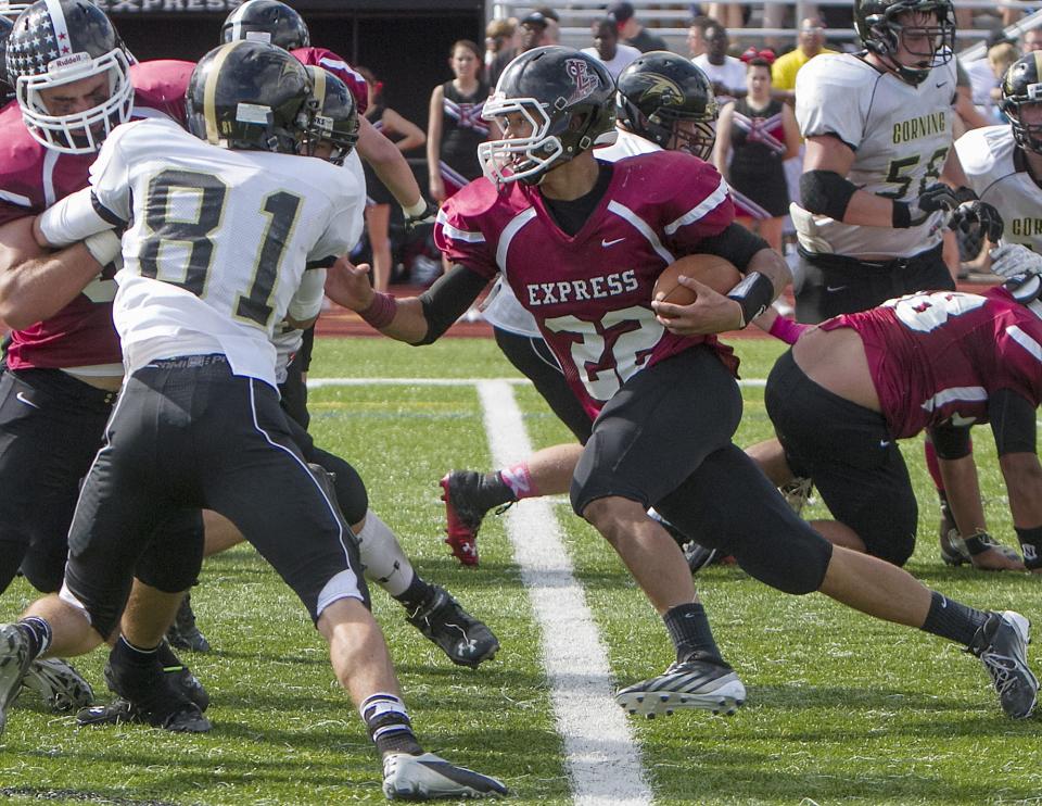 Eli Thomas carries the ball for the Elmira Express in a 22-12 win over Corning in 2013.