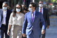 Former Fall River, Mass. Mayor Jasiel Correia, right, and his wife Jenny Fernandes, left, arrive for a court appearance at the John Joseph Moakley United States Courthouse, Monday, Sept. 20, 2021, in Boston. Correia, who was elected at the age of 23 with promises to rejuvenate the struggling mill city, was scheduled to be sentenced for stealing from investors in a smartphone app he created and extorting hundreds of thousands of dollars in bribes from marijuana businesses. (AP Photo/Josh Reynolds)