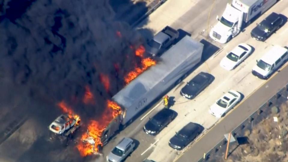 Frame grab from video of cars burning on Interstate 15 during a brush fire in the Cajon Pass, California