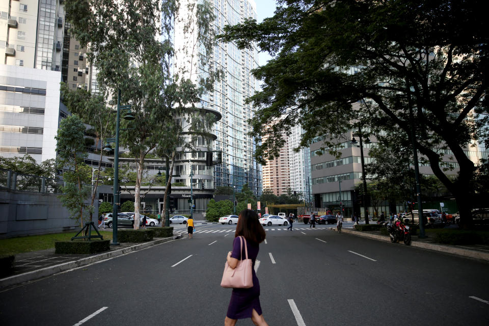 FILE PHOTO: A woman walks to her office in Bonifacio Global City, Taguig City, Metro Manila, November 26, 2018. REUTERS/Eloisa Lopez