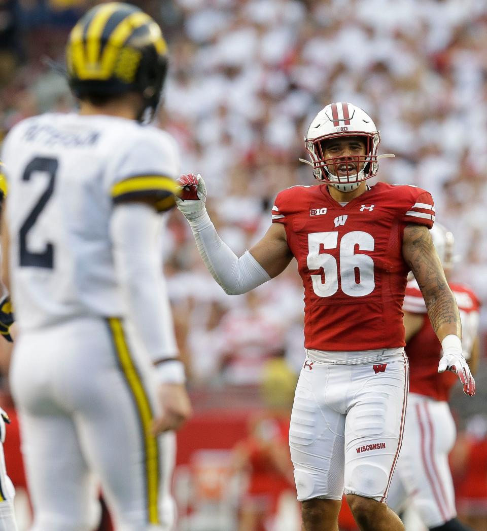 Wisconsin Badgers defensive end Rodas Johnson (56) shares a few words with Michigan Wolverines quarterback Shea Patterson (2) on Saturday, September 21, 2019, at Camp Randall Stadium in Madison, Wis. The Badgers won the game, 35-14.Tork Mason/USA TODAY NETWORK-Wisconsin