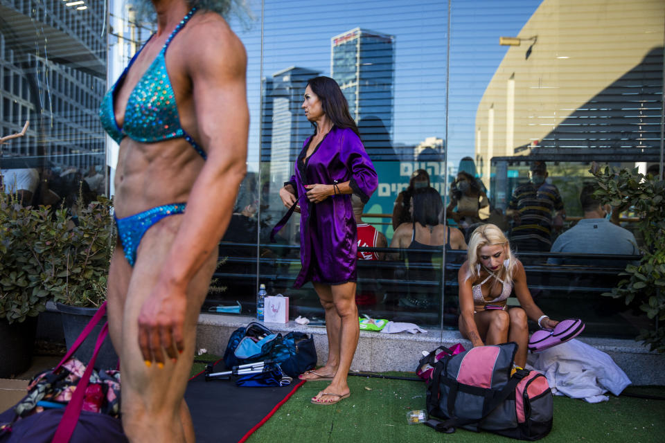 Contestants prepare backstage during the National Amateur Body Builders Association competition in Tel Aviv, Israel, Wednesday, Aug. 19, 2020. Because of the coronavirus pandemic, this year's competition was staged outdoors in Tel Aviv. The 85 participants were required to don protective masks in line with health codes. (AP Photo/Oded Balilty)