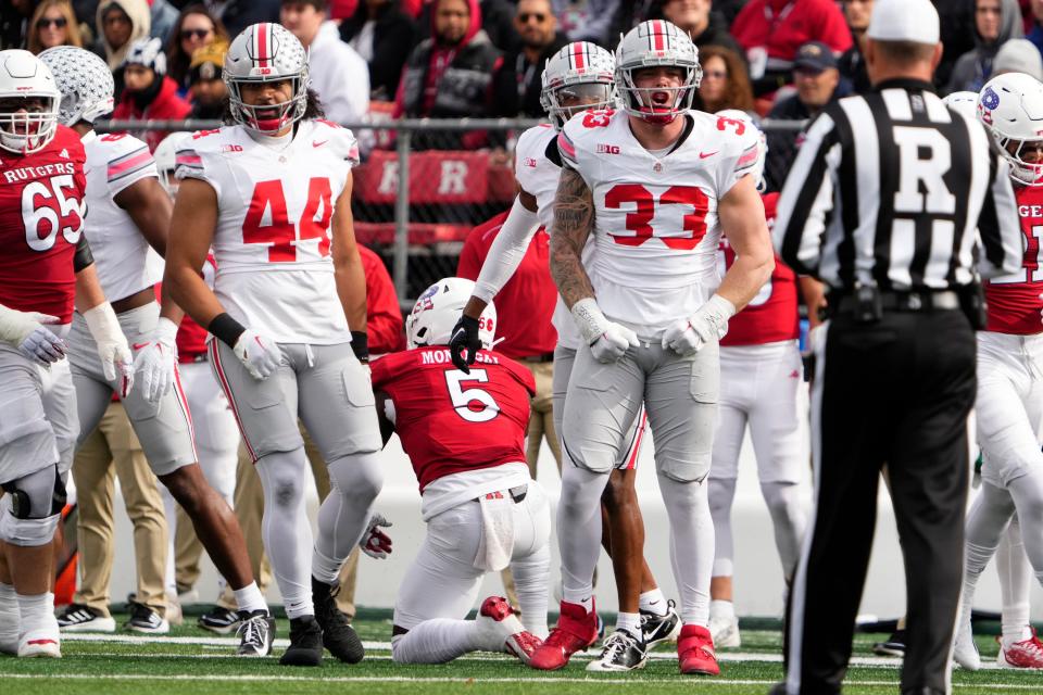 Ohio State defensive end Jack Sawyer celebrates a stop of Rutgers running back Kyle Monangai on Saturday.