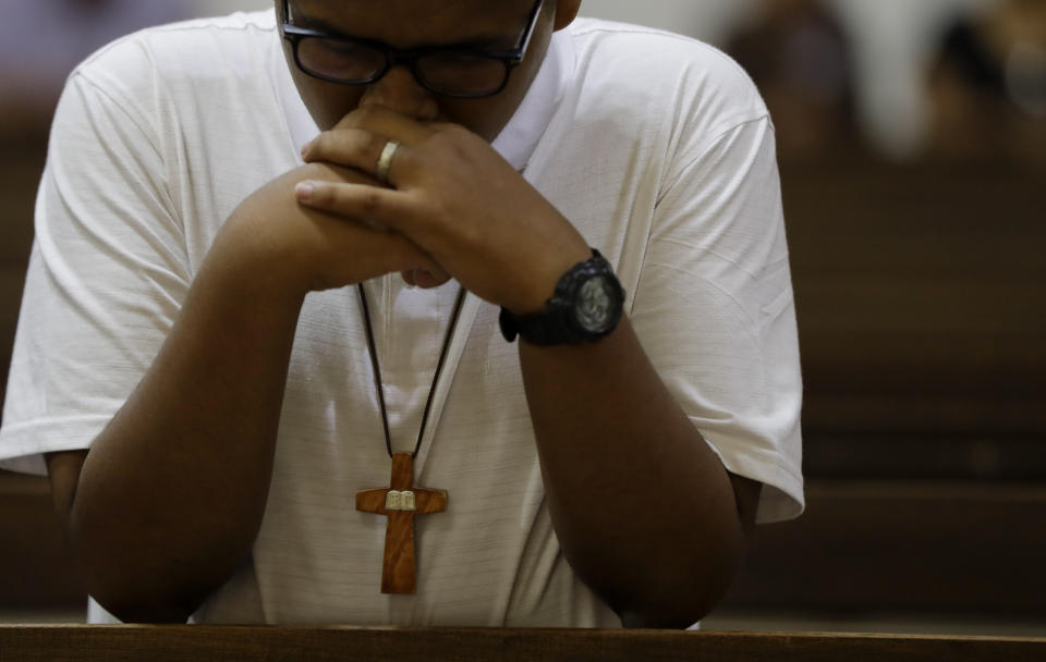 A man prays during a Mass in Oran, Argentina, Tuesday, Jan. 15, 2019. The Vatican received information in 2015 and 2017 that former Bishop of Oran Gustavo Zanchetta, close to Pope Francis, had taken naked selfies, exhibited "obscene" behavior and had been accused of sexually abusing seminarians, a former vicar general told The Associated Press, undermining Vatican claims that the allegations of sexual abuse were only made a few months ago. (AP Photo/Natacha Pisarenko)