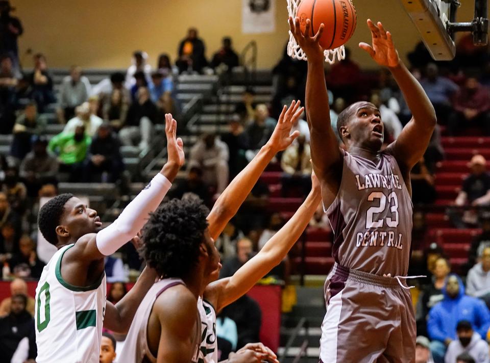 Lawrence Central Bears forward Joshua Mickens (23) reaches for a lay-up against Arsenal Tech Titans on Wednesday, March. 2, 2022, at North Central High School in Indianapolis. Arsenal Tech Titans lead at the half against the Lawrence Central Bears, 35-19. 