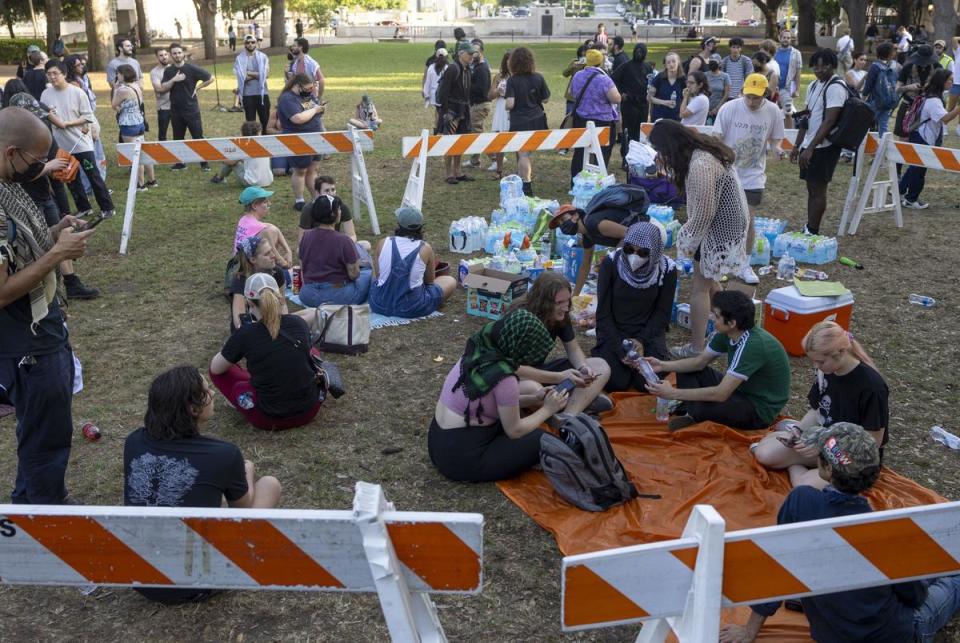 Protestors re-establish a pro-Palestine encampment on the University of Texas-Austin main lawn, utilizing barricades used by police earlier that day on Apr. 29, 2024.