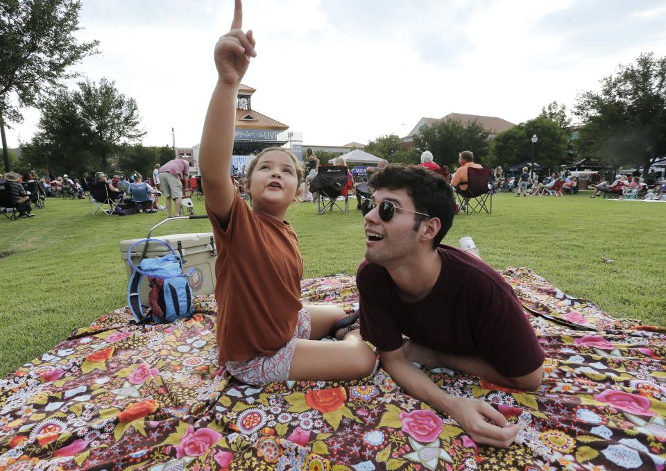 Music fans enjoy the songs of Black Tupelo at the final Live at the Plaza show in July 2019. Coleman Lewis and Salmon Roman look at the sky as they enjoy the concert  at Government Plaza. [Staff Photo/Gary Cosby Jr.]