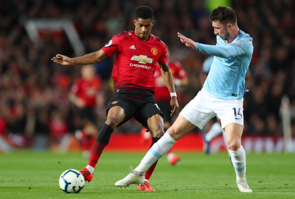 Marcus Rashford of Manchester United battles for possession with Aymeric Laporte of Manchester City during the Premier League match between Manchester United and Manchester City.