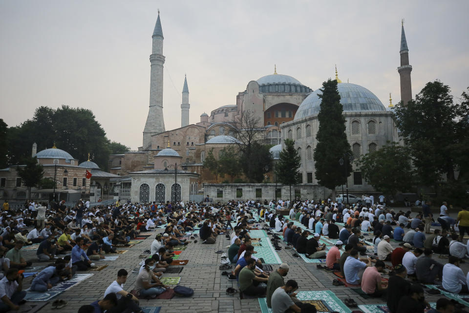 Muslims offer prayers during the first day of Eid al-Adha, outside the iconic Haghia Sophia in the historic Sultan Ahmed district of Istanbul, Tuesday, July 20, 2021. Thousands of Muslims attended dawn Eid al-Adha prayers in Istanbul. (AP Photo/Mucahid Yapici)