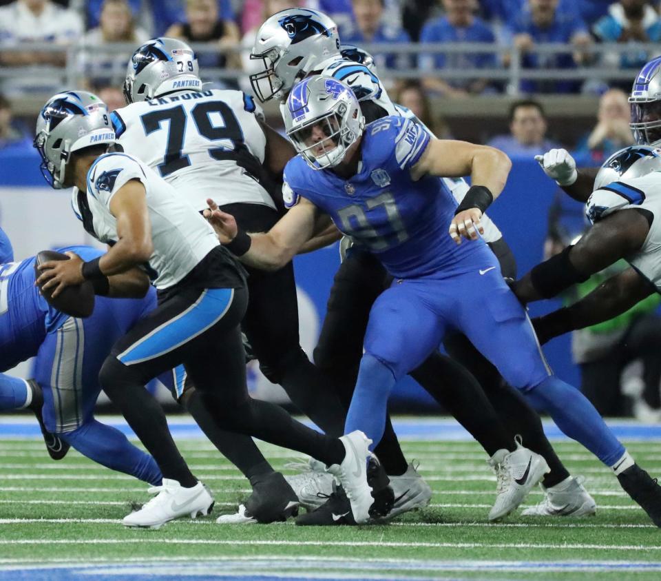 Detroit Lions defensive end Aidan Hutchinson (97) pressures Carolina Panthers quarterback Bryce Young (9) during first-half action at Ford Field in Detroit on Sunday, Oct, 8, 2023.