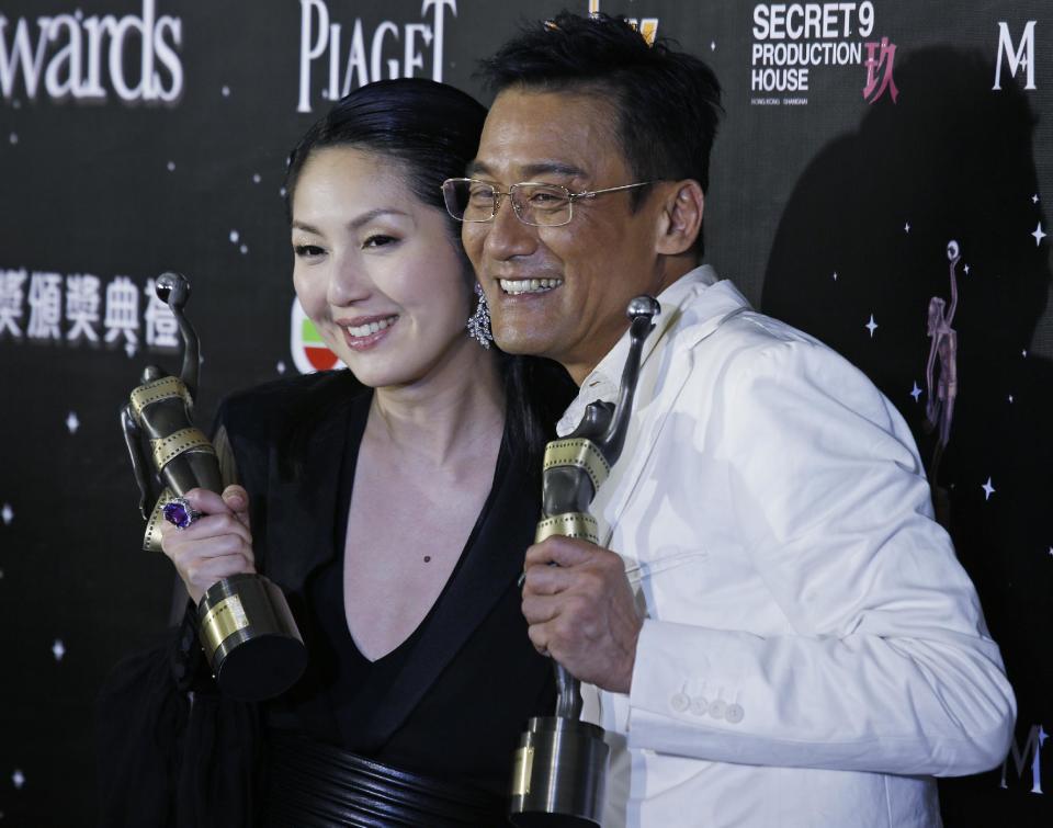 Hong Kong actress Miriam Yeung, left, and actor Tony Leung Ka Fai poses after winning the Best Actress award and Best Actor award at the 32nd Hong Kong Film Awards in Hong Kong Saturday, April 13, 2013. (AP Photo/Vincent Yu)