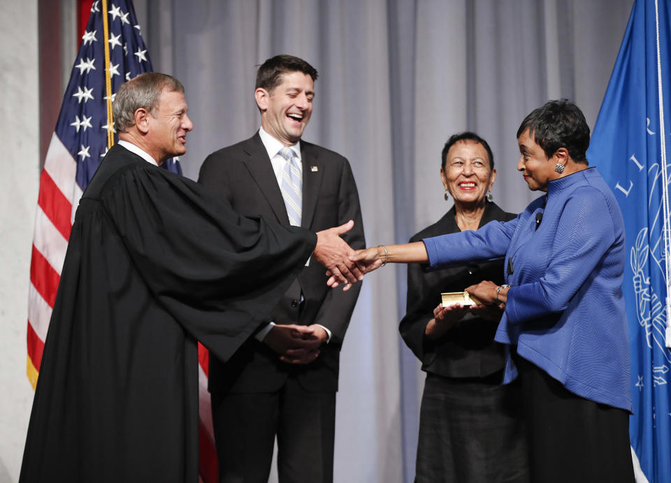 Chief Justice John Roberts, left, shakes hands with the new Librarian of Congress Carla Hayden