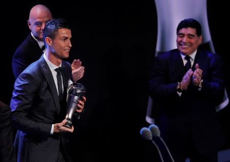 Soccer Football - The Best FIFA Football Awards - London Palladium, London, Britain - October 23, 2017 Real Madrid’s Cristiano Ronaldo celebrates after winning The Best FIFA Men’s Player Award as FIFA President Gianni Infantino and former Argentina player Diego Maradona look on REUTERS/Eddie Keogh