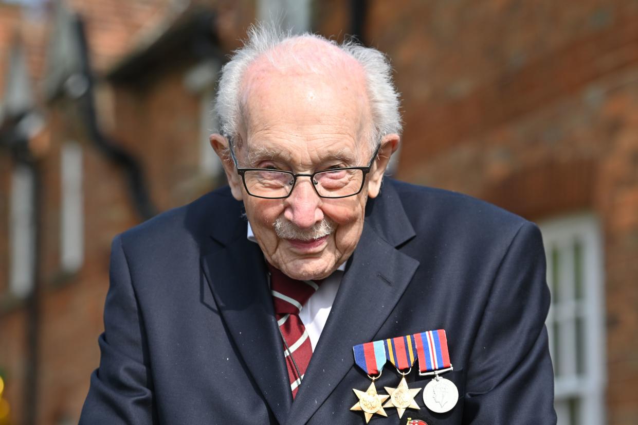 British World War II veteran Captain Tom Moore, 99, poses doing a lap of his garden in the village of Marston Moretaine, 50 miles north of London, on April 16, 2020. - A 99-year-old British World War II veteran Captain Tom Moore on April 16 completed 100 laps of his garden in a fundraising challenge for healthcare staff that has "captured the heart of the nation", raising more than £13 million ($16.2 million, 14.9 million euros). "Incredible and now words fail me," Captain Moore said, after finishing the laps of his 25-metre (82-foot) garden with his walking frame. (Photo by JUSTIN TALLIS / AFP) (Photo by JUSTIN TALLIS/AFP via Getty Images)