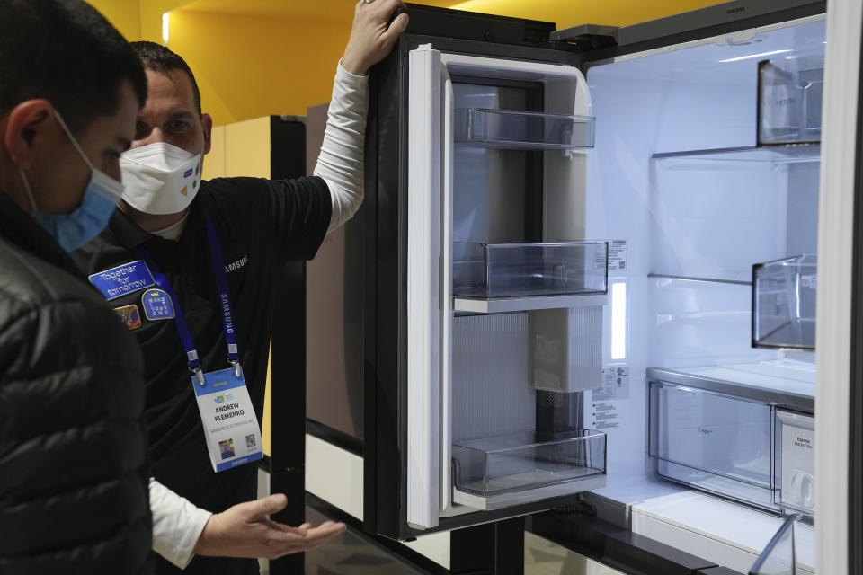 File - Andrew Klemenko shows off a Smart Counter Depth BESPOKE 4-Door Flex refrigerator at the Samsung booth during the CES tech show in Las Vegas. At the dawn of 2024, also known as New Year's resolution season, there are lots of small, easily achievable ways to lead more climate friendly lives. (AP Photo/Joe Buglewicz, File)