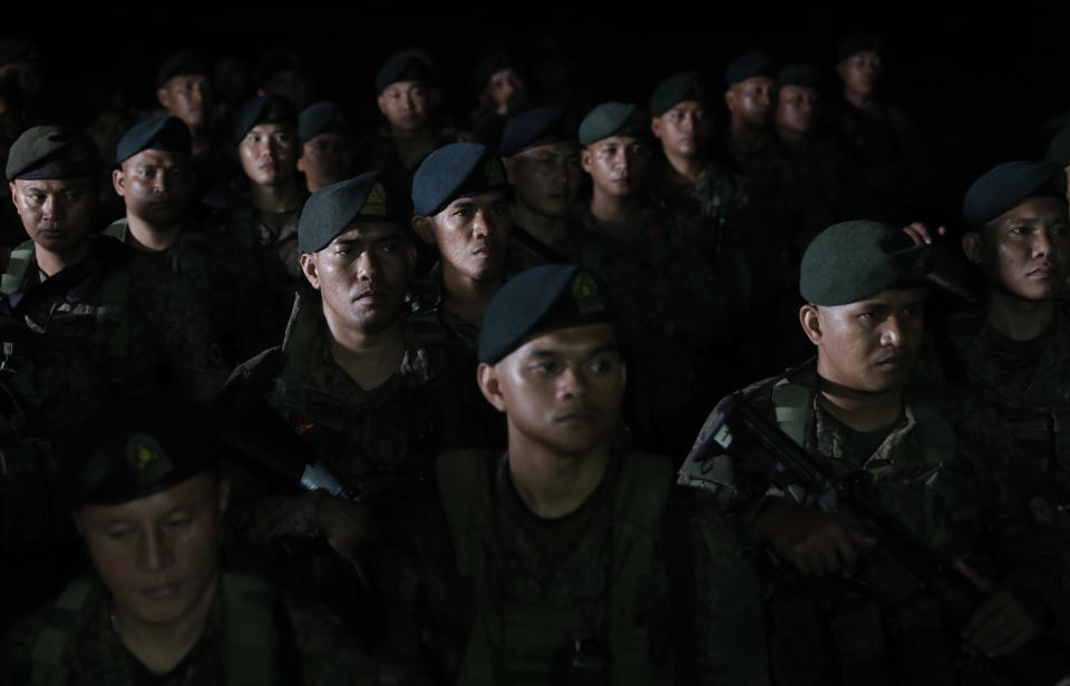 Filipino troopers listen to instructions as they wait to be deployed at checkpoints in the metropolis as part of the government's preventive measure against the spread of the new coronavirus in Manila, Philippines on Saturday March 14, 2020. Philippine officials on Saturday declared a night curfew in the capital and said millions of people in the densely populated region could only go out of their homes for work, buy necessities and medical emergencies at daytime under a monthlong quarantine to be imposed to fight the new coronavirus. For most people, the new coronavirus causes only mild or moderate symptoms. For some, it can cause more severe illness, especially in older adults and people with existing health problems. (AP Photo/Aaron Favila)