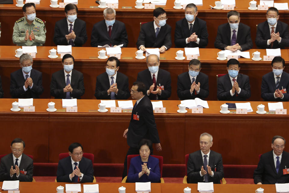 Delegates applaud as Chinese Premier Li Keqiang prepares to speak during the opening session of China's National People's Congress (NPC) at the Great Hall of the People in Beijing, Friday, May 22, 2020. (AP Photo/Ng Han Guan, Pool)