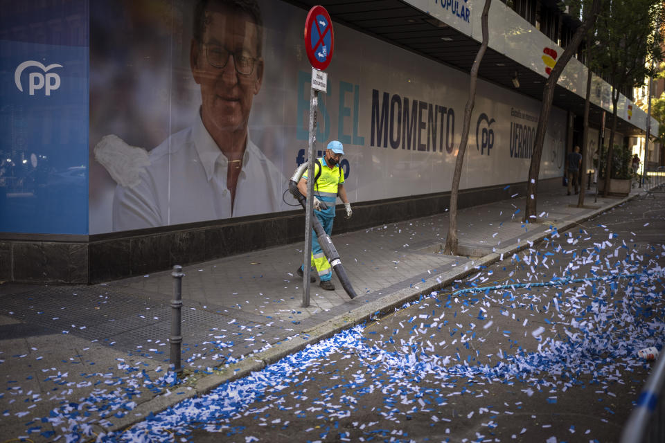 A worker cleans the street after celebrations at the conservative Popular Party headquarter in Madrid, Spain, Monday, July 24, 2023. Spain is in political disarray after elections left no party with a clear path to forming a government. The uncertainty deepened as both of the country’s two main parties indicated that they hope to take power. (AP Photo/Emilio Morenatti)