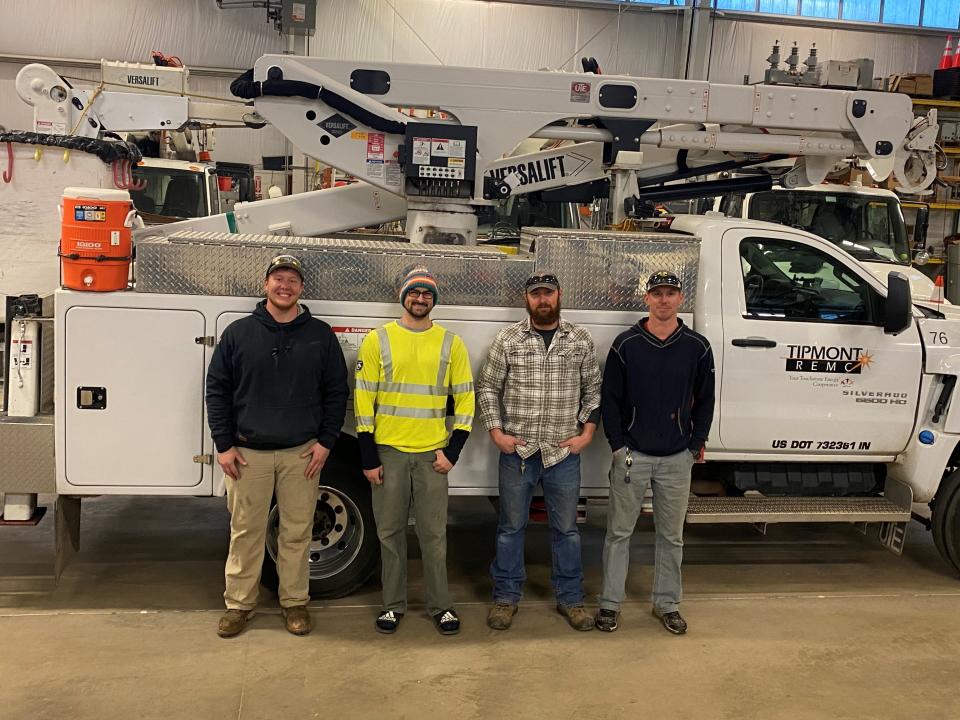 Tipmont REMC line workers (from left) Tristen Hoffman, Garret Foutch, Bo Bouwkamp, and Dustin Manns with a Tipmont REMC bucket truck prior to departing for Rappahannock Electric Cooperative on Monday, Jan. 3, 2022.