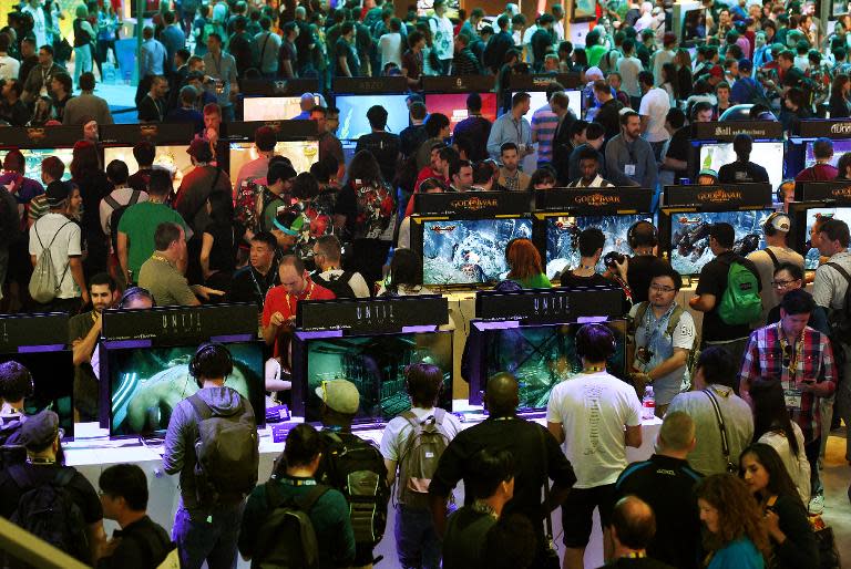 Gamers test new video games on display at the Sony Playstation area, on the opening day of the Electronic Entertainment Expo, known as E3, at the Convention Center in Los Angeles, California, on June 16, 2015