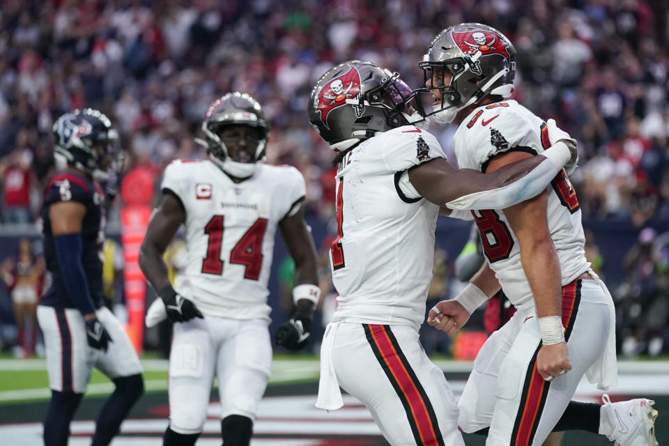 Tampa Bay Buccaneers tight end Cade Otton, right, celebrates his touchdown catch with running back Rachaad White, second from right, during the second half of an NFL football game against the Houston Texans, Sunday, Nov. 5, 2023, in Houston. (AP Photo/Eric Gay)