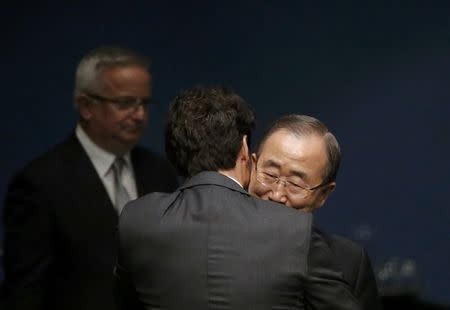 Canadian Prime Minister Justin Trudeau embraces U.N. Secretary General Ban Ki-moon (R) after signing the Paris Agreement on climate change at United Nations Headquarters in Manhattan, New York, U.S., April 22, 2016. REUTERS/Carlo Allegri