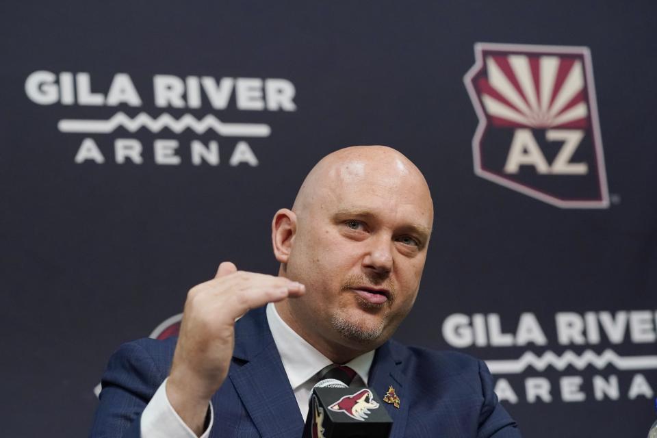 FILE - In this July 1, 2021, file photo, Arizona Coyotes new head coach Andre Tourigny speaks during an NHL hockey news conference at Gila River Arena in Glendale, Ariz. The Coyotes are in their second year of rebuilding under Tourigny after finishing with the NHL’s second-worst record a year ago. (AP Photo/Ross D. Franklin, File)