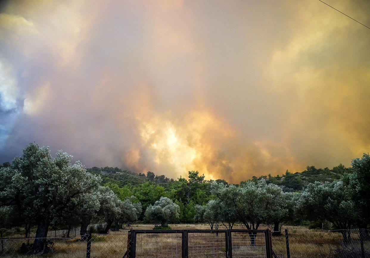 Smoke rises from a wildfire on the island of Rhodes, Greece, July 22, 2023. (Argiris Mantikos/Eurokinissi via Reuters)