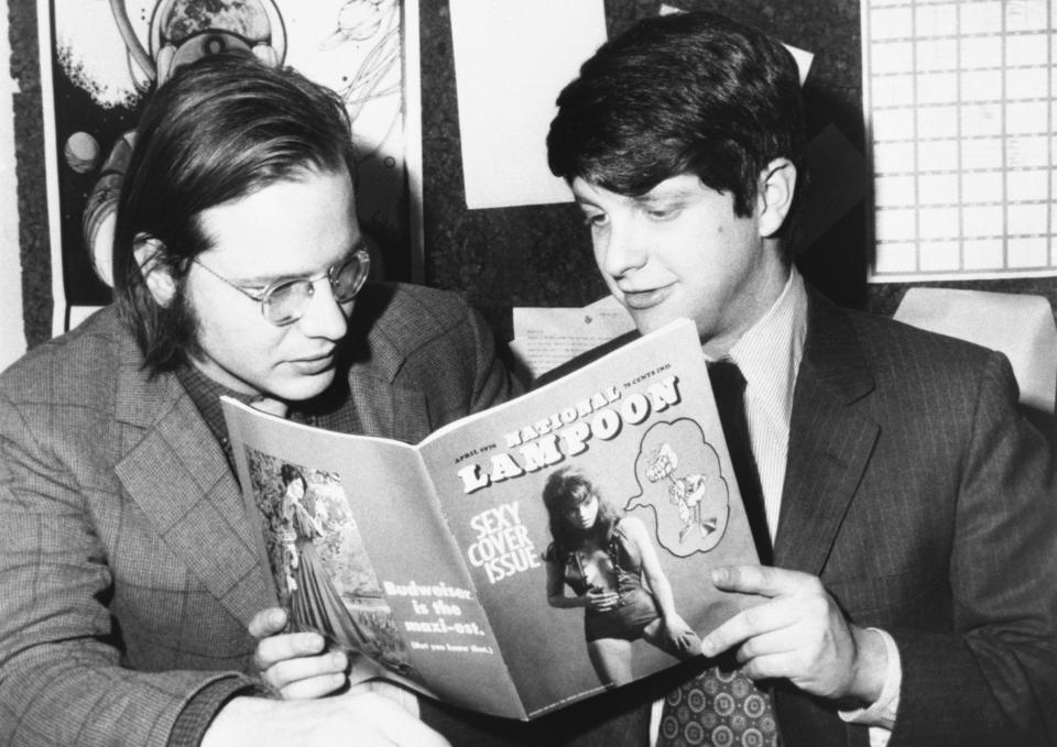 Robert Hoffman, managing editor, and Douglas C. Kenney, editor, look over the first copy of National Lampoon - a monthly humor magazine with each issue treating a separate topic with the satirical style of the famous university magazine it parodies.