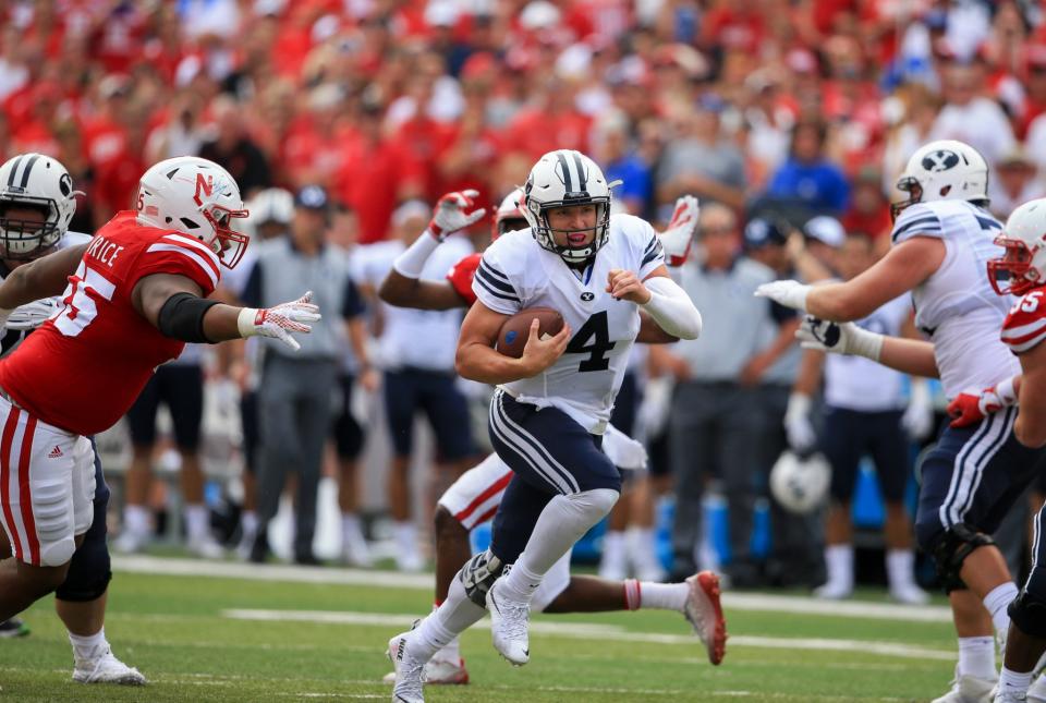 Brigham Young quarterback Taysom Hill (4) runs through a gap during the first half of an NCAA college football game against Nebraska in Lincoln, Neb., Saturday, Sept. 5, 2015. (AP Photo/Nati Harnik)