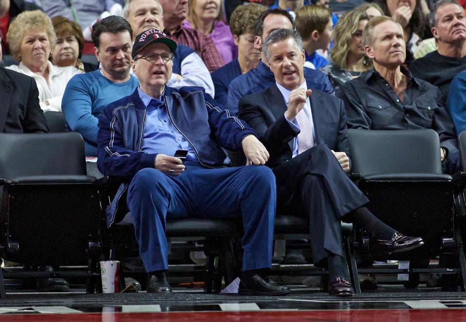 FILE - In this Jan. 10, 2016 file photo, Portland Trail Blazers owner Paul Allen, left, and general manager Neil Olshey appear during the second half of an NBA basketball game in Portland, Ore. Allen, billionaire owner of the Trail Blazers and the Seattle Seahawks and Microsoft co-founder, died Monday, Oct. 15, 2018 at age 65. Earlier this month Allen said the cancer he was treated for in 2009, non-Hodgkin’s lymphoma, had returned. (AP Photo/Craig Mitchelldyer, File)