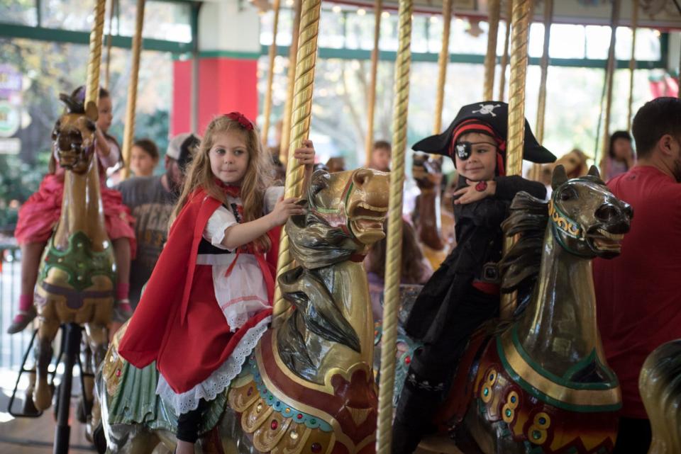 Costumed kids ride the Columbus Zoo's Grand Carousel at a "Boo at the Zoo" event.