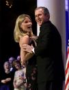 President Bush grins as his daughter Jenna, 19, adjusts her dress, as they dance at the Florida Inaugural Ball at the National Building Museum in Washington, Saturday, Jan. 20, 2001. (AP Photo/Doug Mills)