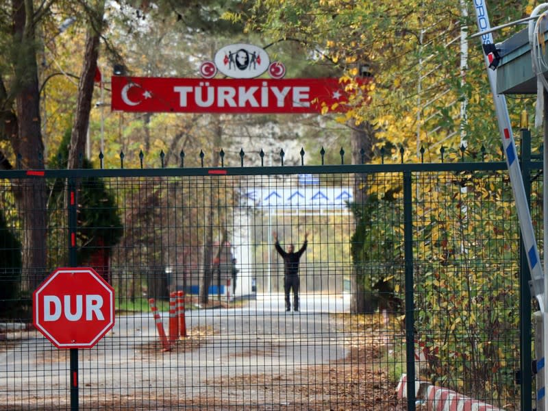 A man, a U.S. citizen of Arab descent and Islamic State suspect who was deported by Turkey, stands on the no-man's land between Turkey and Greece, as he is pictured from the Pazarkule border crossing near Edirne