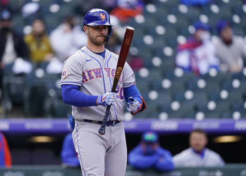 New York Mets' Pete Alonso stares at his bat while facing Colorado Rockies starting pitcher Chi Chi Gonzalez in the first inning in the first baseball game of a doubleheader, Saturday, April 17, 2021, in Denver. (AP Photo/David Zalubowski)
