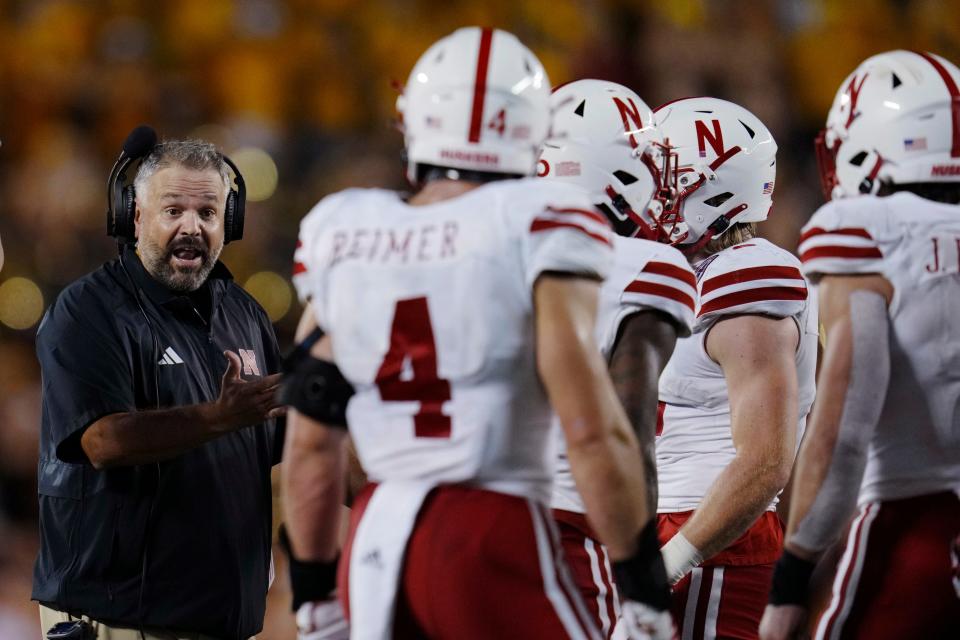 Nebraska coach Matt Rhule, left, talks with players during the second half of the team's NCAA college football game against Minnesota, Thursday, Aug. 31, 2023, in Minneapolis. (AP Photo/Abbie Parr)