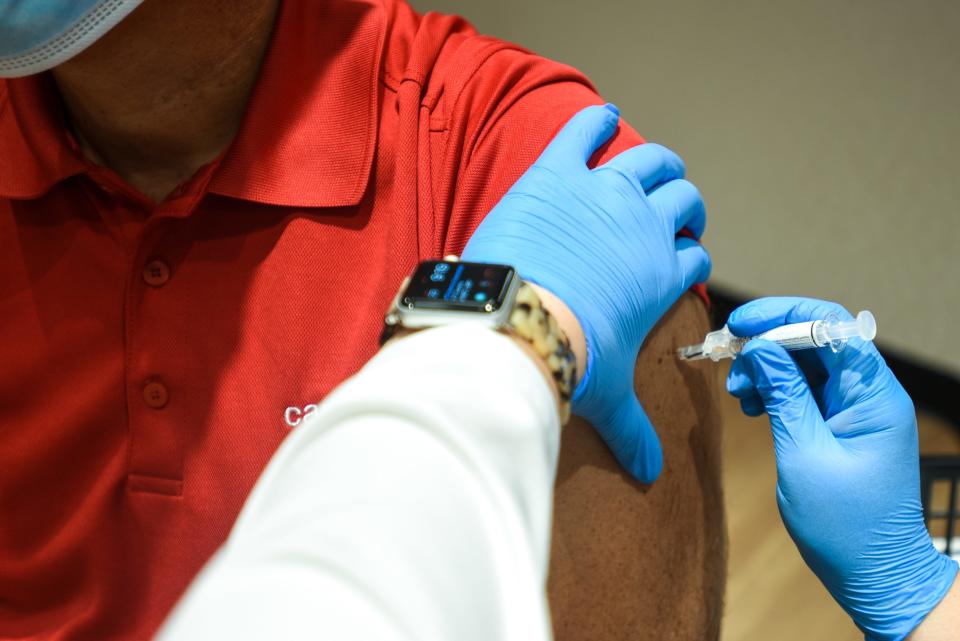 District Leaders at CVS Health Jennifer Rudell and Rob Muse go through CVS' process to receive vaccinations for both COVID-19 and flu shots. Muse received a flu shot. Flu hospitalizations have risen in southwest Ohio in recent weeks.