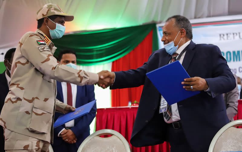 Lieutenant General Mohamed Hamdan Dagalo and Sudan's Kush Movement Chairman Mohamed Dawood greet after the signing of a peace agreement with the country's five key rebel groups in Juba