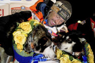 FILE - In this March 18, 2020 file photo, Thomas Waerner, of Norway, celebrates his win in the Iditarod Trail Sled Dog Race in Nome, Alaska. The world's most famous sled dog race will go forward in 2021 officials are preparing for every potential contingency now for what the coronavirus and the world might look like in March when the Iditarod starts. It's not the mushers that worry Iditarod CEO Rob Urbach; they're used to social distancing along the 1,000 mile trail. The headaches start with what to do with hundreds of volunteers needed to run the race, some scattered in villages along the trail between Anchorage and Nome, to protect them and the village populations. (Marc Lester/Anchorage Daily News via AP, File)