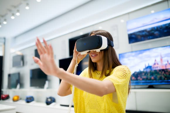 A woman uses a VR headset.