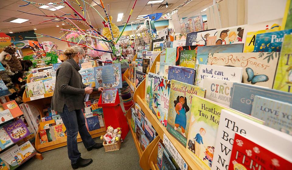 Buttonwood book buyer Kristine Jelstrom stocks a display with the new Jan Brett book "The Nutcracker" at Buttonwood Books and Toys in Cohasset on Thursday, Nov. 18, 2021.